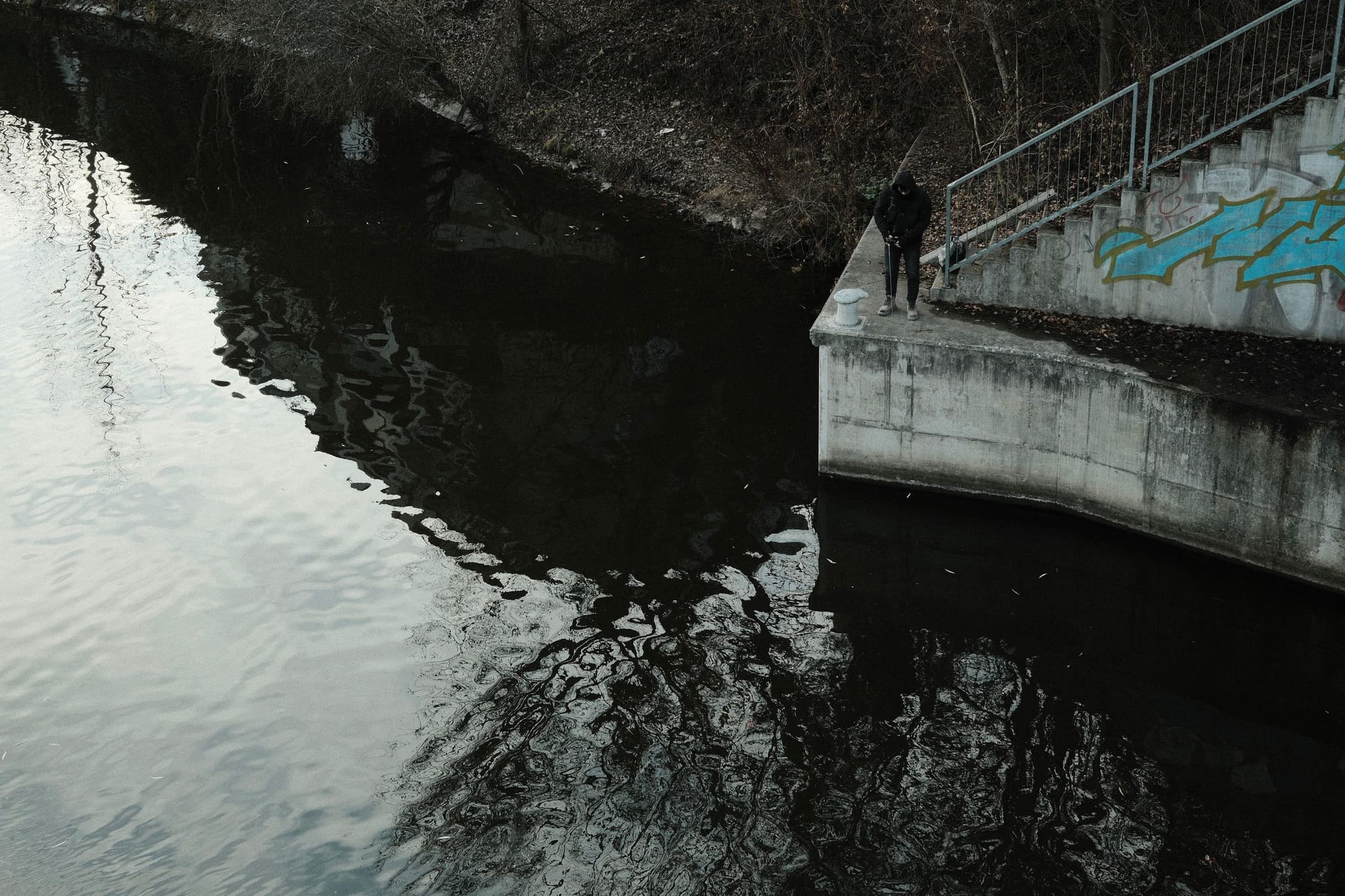 Lone Fisherman by the Canal